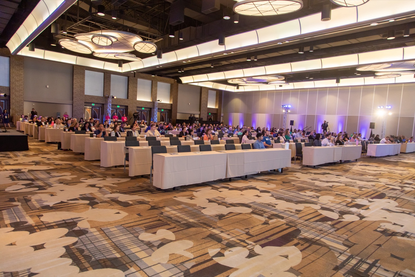 A full conference ballroom — room size and attendee count are two of the biggest drivers of corporate video cost