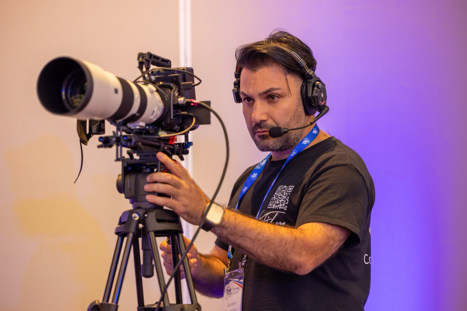 Connery Davoodian operating camera with a long lens at a Los Angeles conference