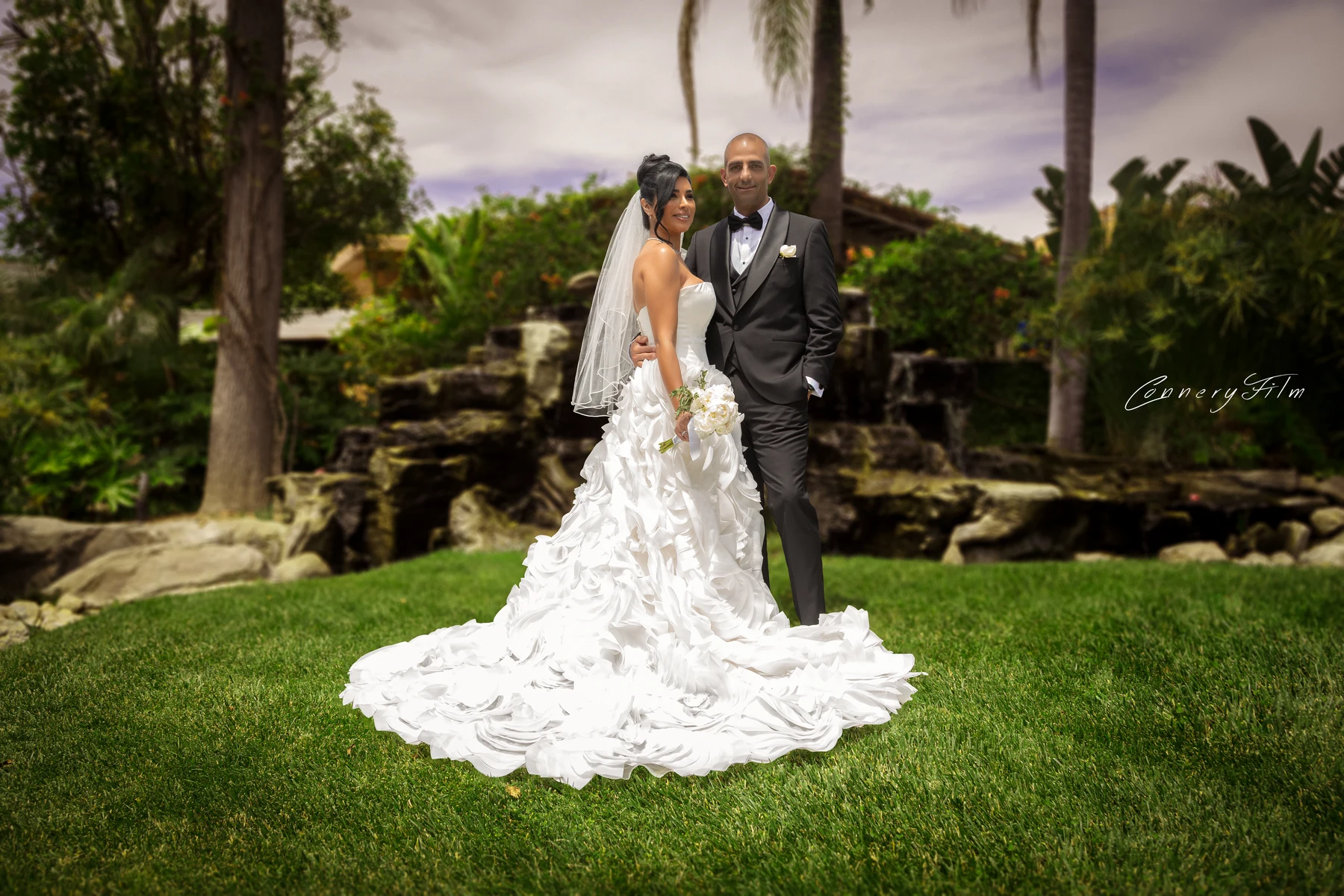 A Los Angeles couple reviewing their wedding photography contract and payment options at a bright studio consultation table.