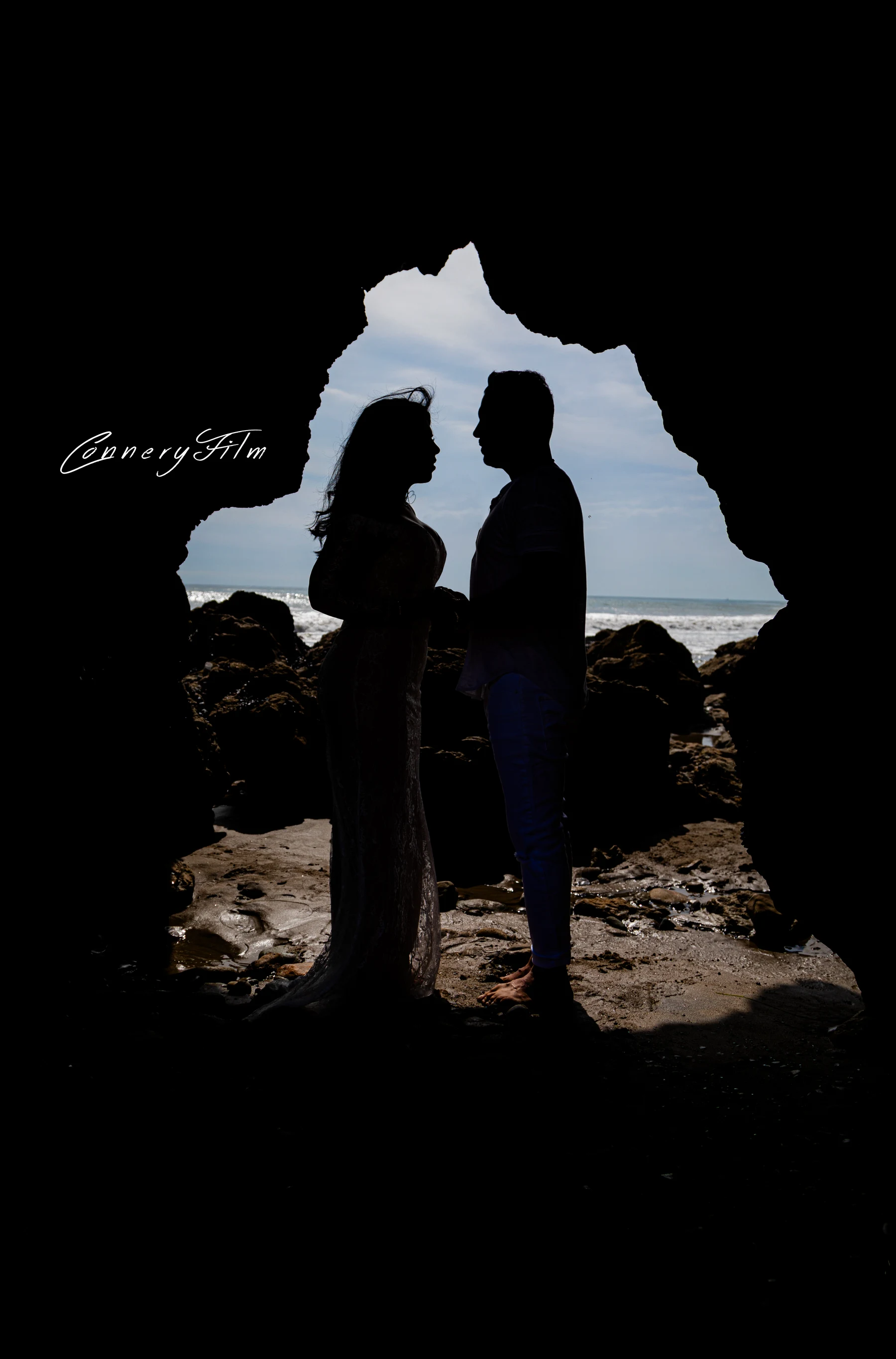 Engaged couple laughing together during a golden hour engagement photo session on a Malibu bluff in Los Angeles