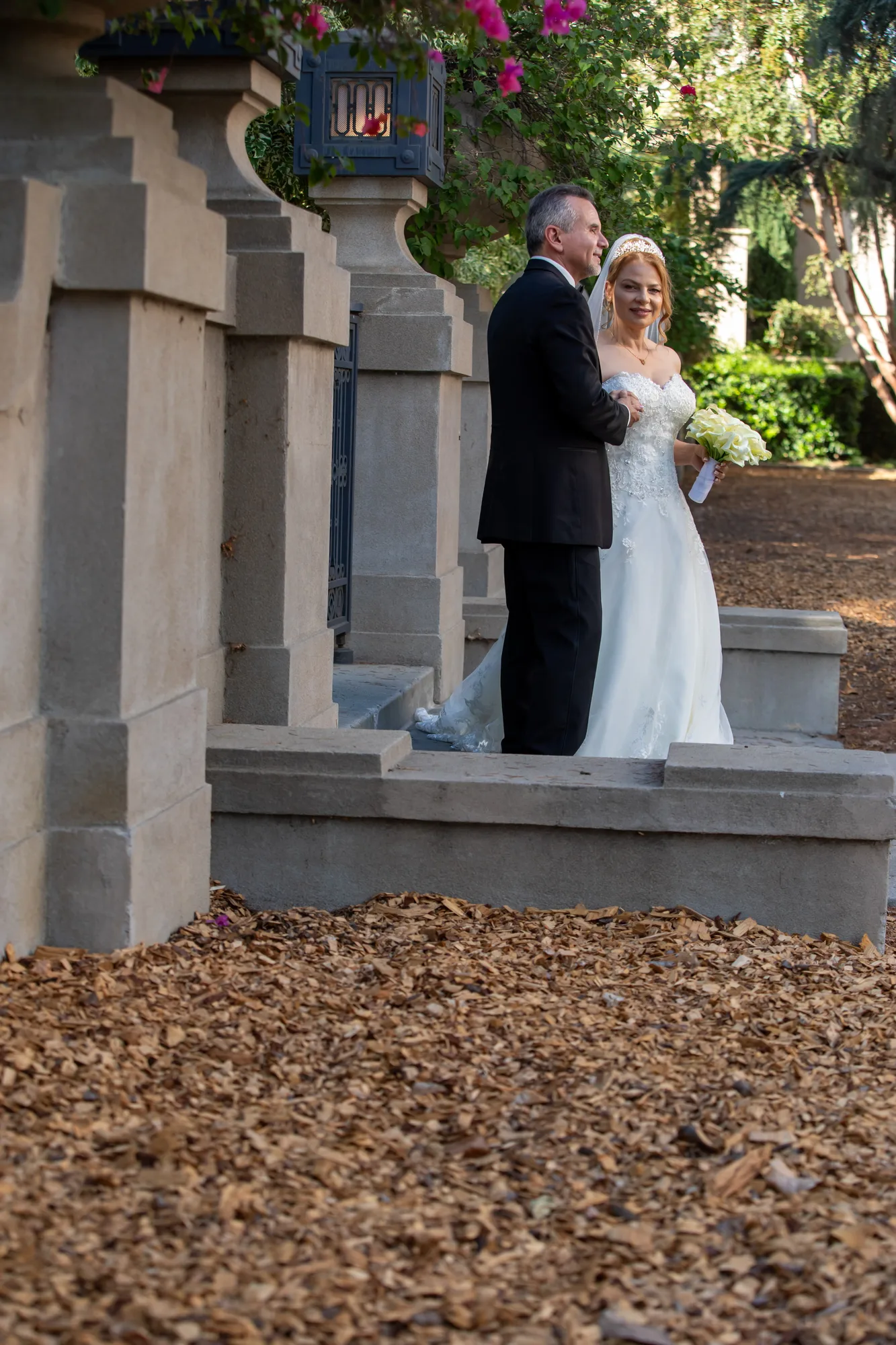 Couple on the stone steps of the mansion terrace at Ambassador Mansion & Gardens
