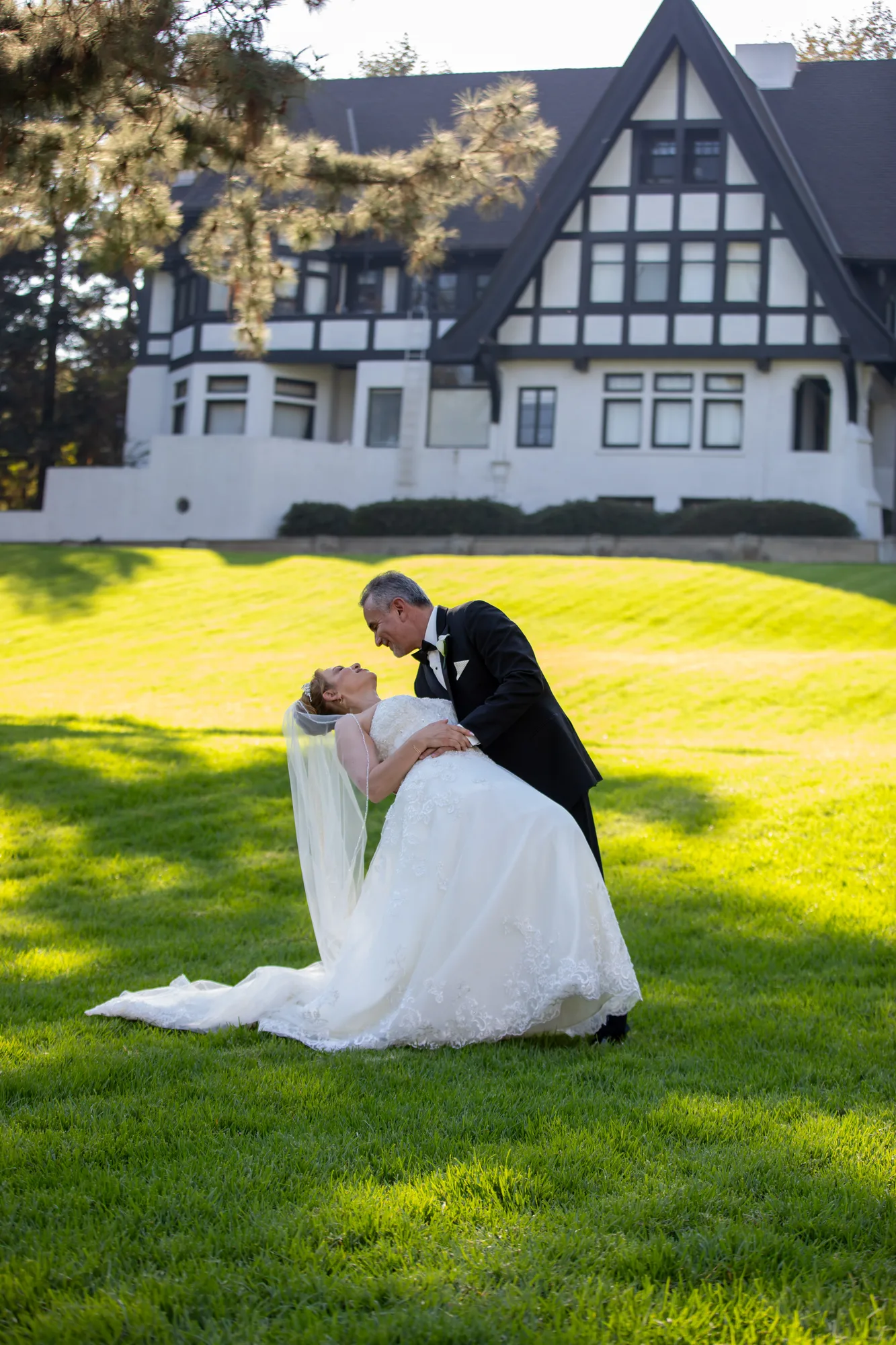 Groom dipping the bride on the open lawn at Ambassador Mansion & Gardens, Pasadena
