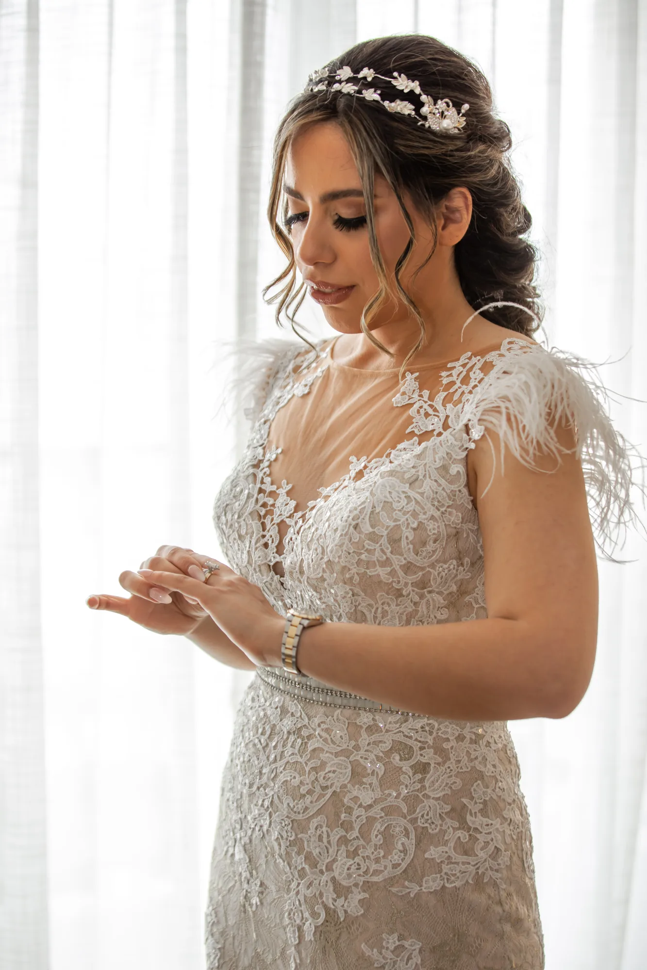 Full-length bridal portrait against the sheer curtains of an ocean-facing suite at Paséa