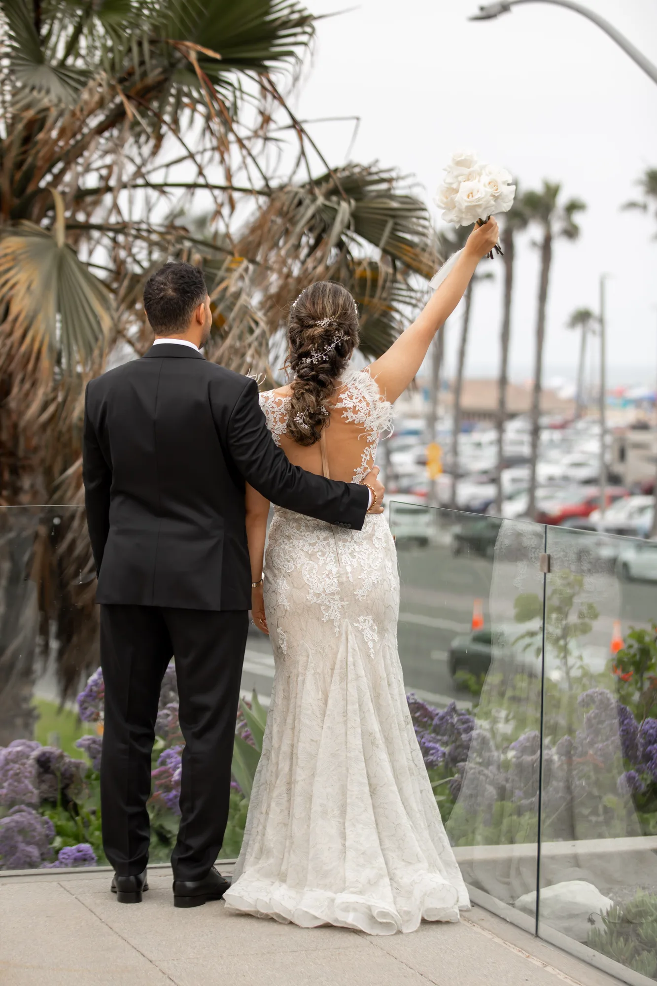 Couple at the glass railing overlooking Huntington Harbour from Paséa Hotel & Spa