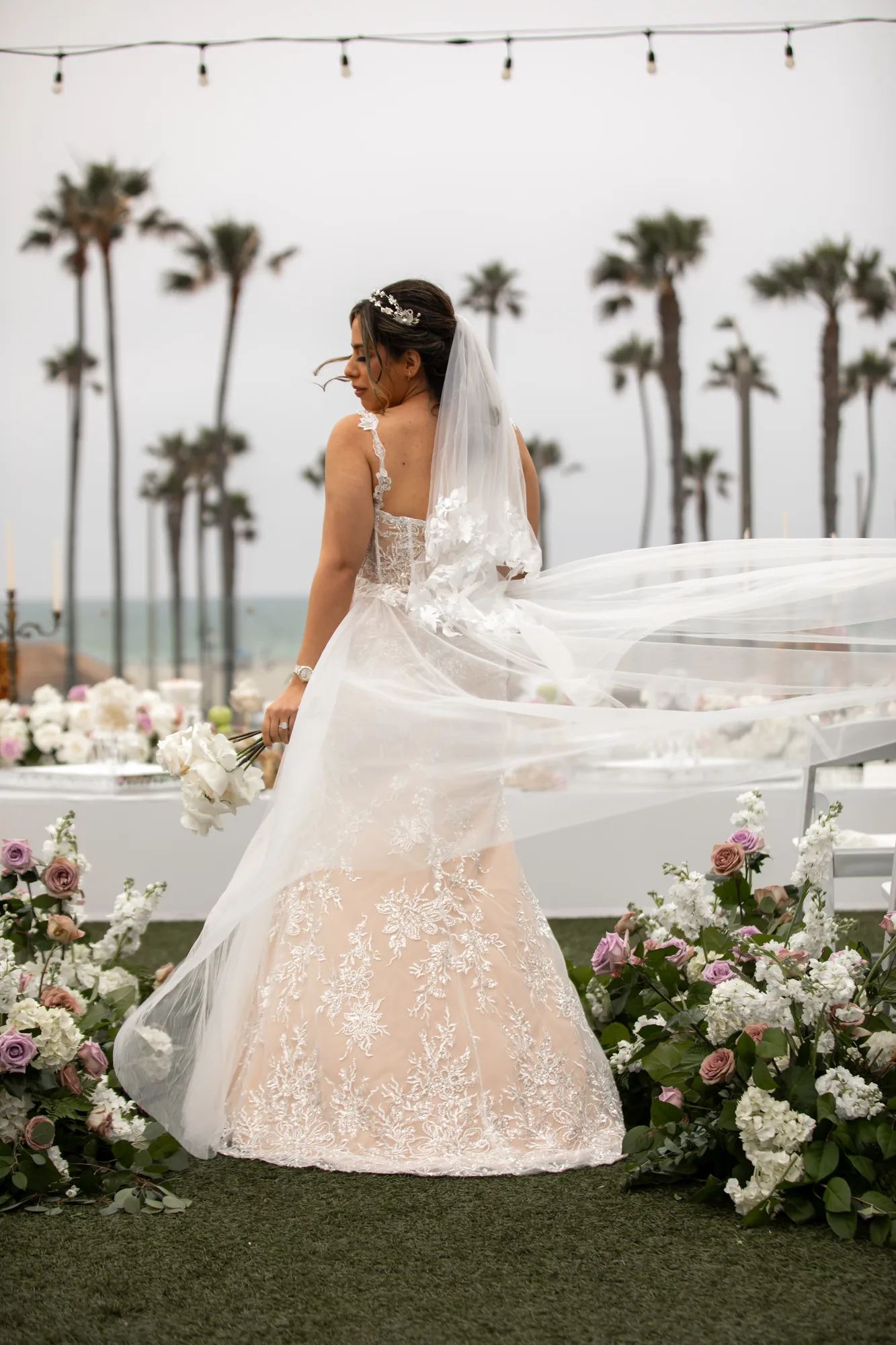 Bride's veil lifting in the coastal wind on the lawn at Paséa Hotel & Spa