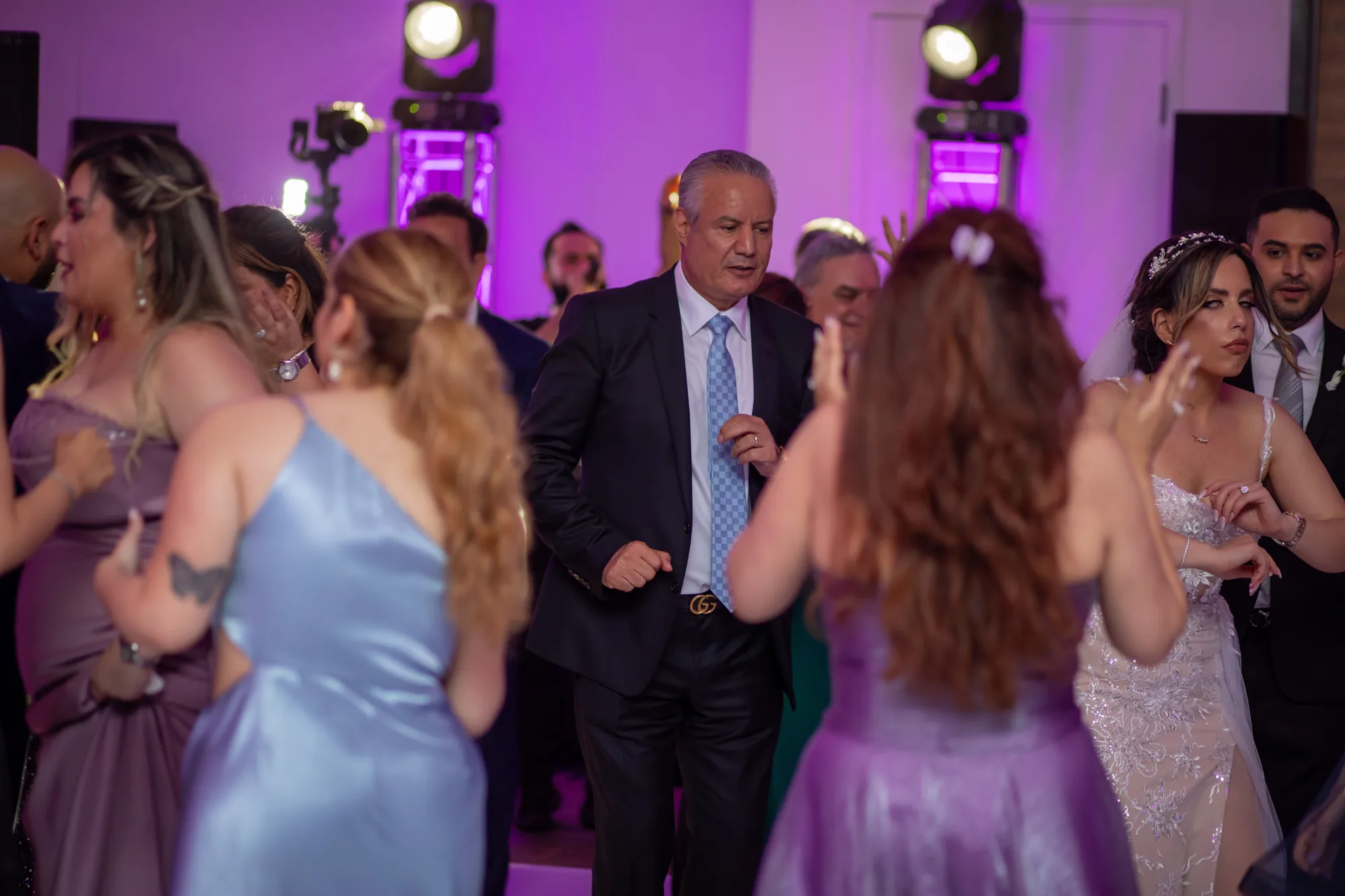 Guests dancing under purple uplighting in the ballroom at Paséa Hotel & Spa