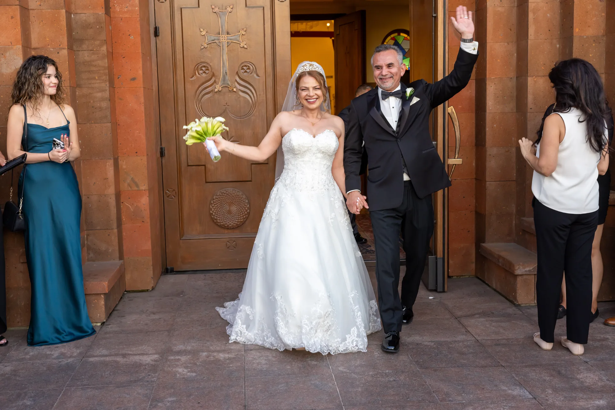 Bride and groom's recessional through the carved tuff-stone doorway of St. Leon Cathedral
