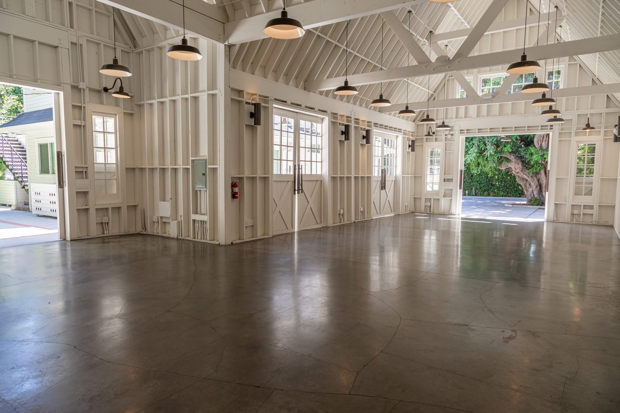The barn at Lombardi House, pendant lights along the trusses and both ends open