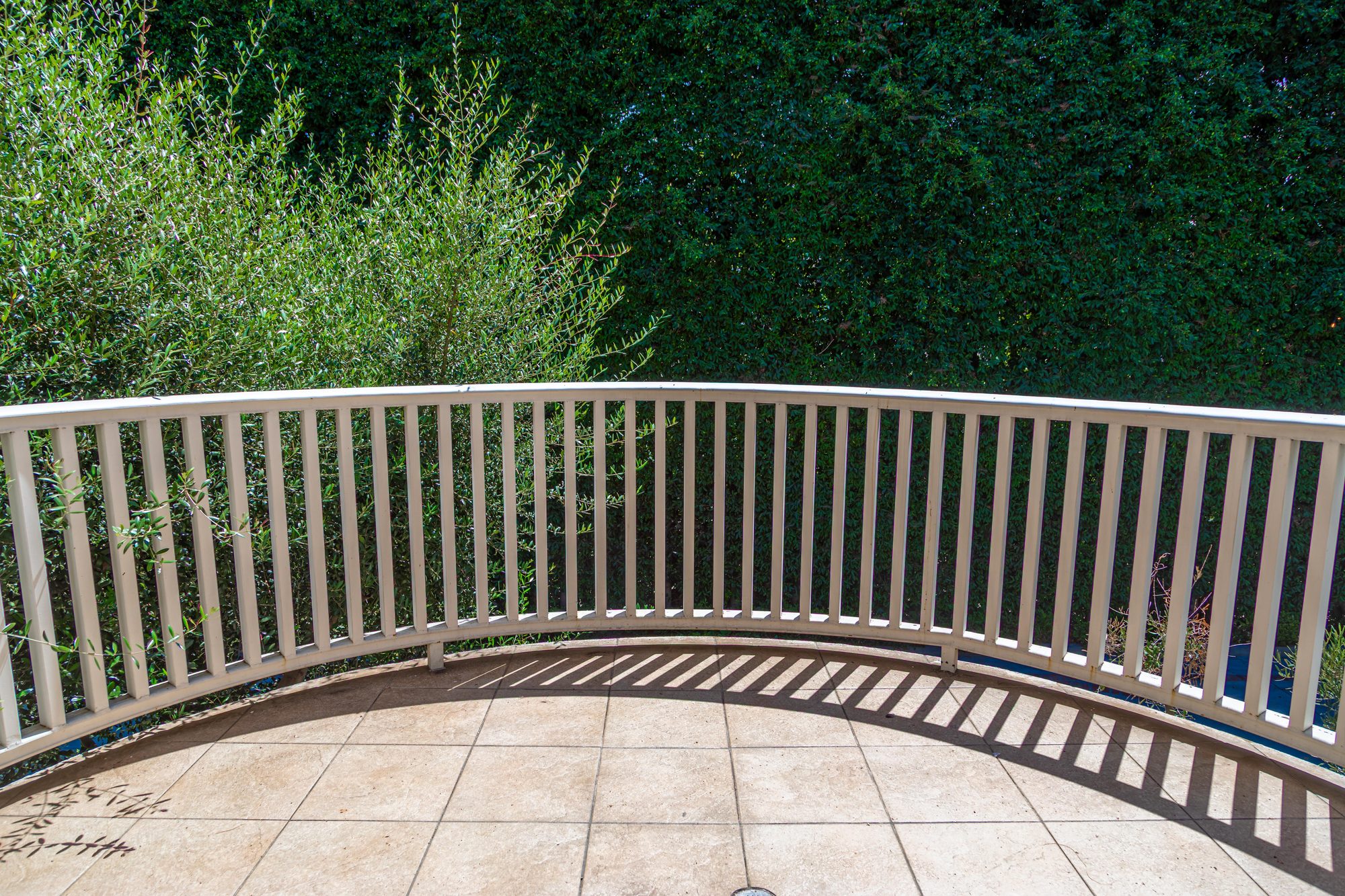 The curved veranda at Lombardi House, looking into the hedges