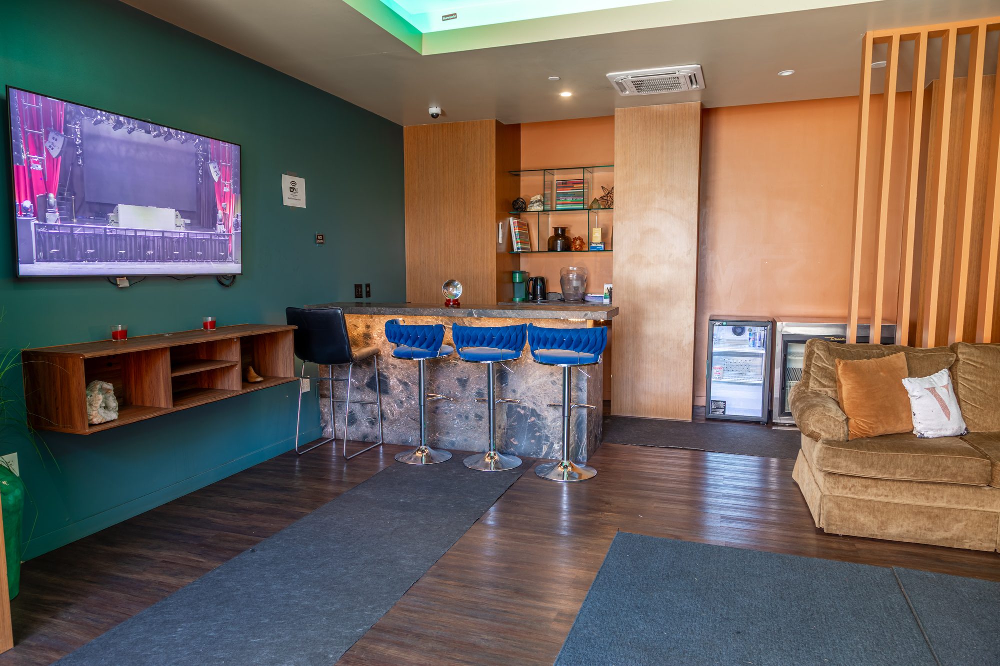 A green room at The Vermont Hollywood with its own bar and screen